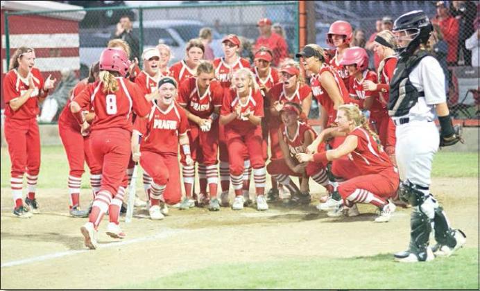 The Prague Lady Devils celebrate at home plate after a home run against Meeker. Photo/Brian Blansett