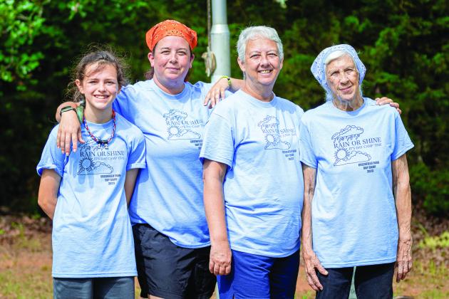 Four generations of Girl Scouts: from left, Adelaide Furtado, Michelle Cross-Furtado, Sherie Greenfield-Jones and Gerry Greenfield-Elliott. The family of Girl Scouts stands in front of the flagpole at Greenfield Farm Day Camp after the camp’s final opening flag ceremony. Photo/Evan Kennemer