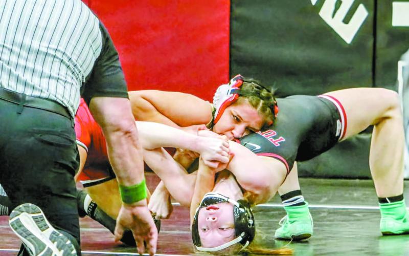 McLoud’s Yazmin Nevarez (red headgear) dominates Tuttle’s Poet Smathers en route to a pin during the Class 5A regional wrestling tournament at Weatherford last week. Nevarez won the regional and helped McLoud to a team championship. She will lead a contingent of 25 area wrestlers to the state tournament in Oklahoma City this weekend. Photo/Jennifer Pryor