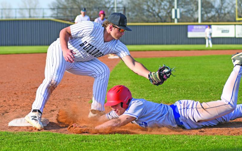 Chandler runner Levi Becktol dives back to third under the tag of Meeker third baseman Maverick Herring. Photo/Brian Blansett