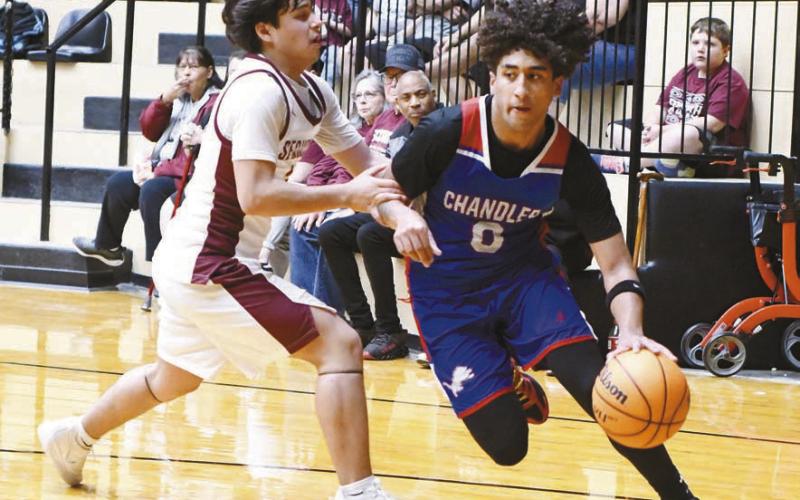 Chandler senior Javarious Wade penetrates on the dribble against Sequoyah-Tahlequah. Photo/Brian Blansett