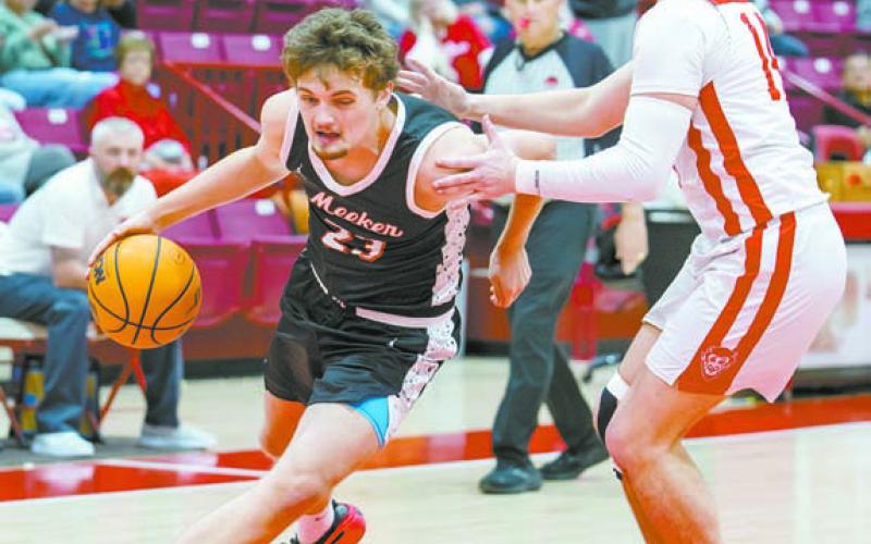 Left, Meeker senior Castin Schafer rounds the corner on Prague’s Karson Young during Meeker’s district win last week. Photo/Rick Hester. Right, Chandler’s Jordan Denson drives the lane against Beggs Friday night in district tournament play. The seventh-ranked Lions won, 74-49. Photo/ Brian Blansett