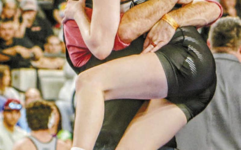 McLoud sophomore Carli Sisco celebrates her second consecutive state champi-See onship with coach William Winters. Photo/Jennifer Pryor