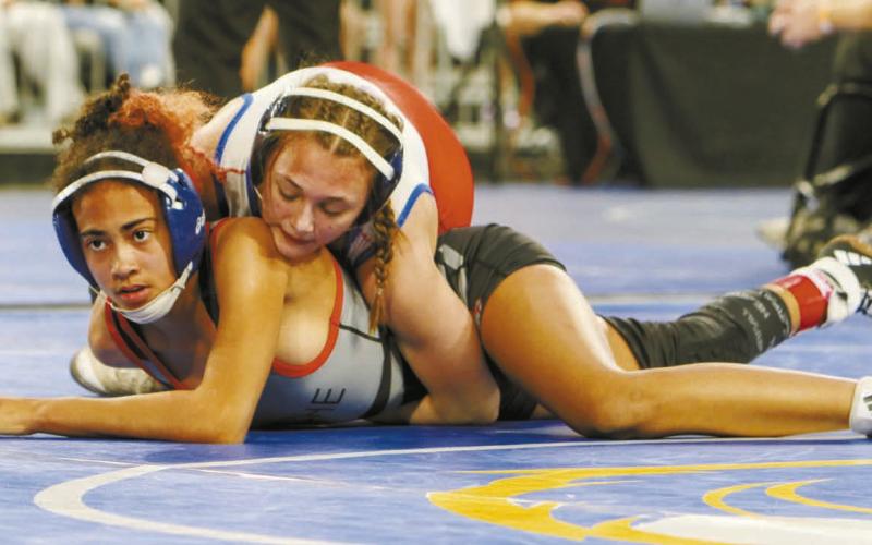 Chandler’s Lizzy Pryor (in white) goes for a pin against Tiana Fox from Cache in the third-place match. Photo/Jennifer Pryor