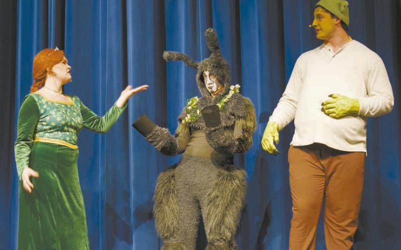 Above, members of the ensemble dance during “Story of My Life” in Chandler High School’s production of “Shrek the Musical.” From left to right are Silas Martin, Alison Radcliffe, Julia Garder, Reagan Moehle and Brooklyn Hammons. Below are three of the stars of the show: Bethany Descher as Fiona, James Kerr as Donkey and Eli Smithey as Shrek. Photos/Emily Kalka