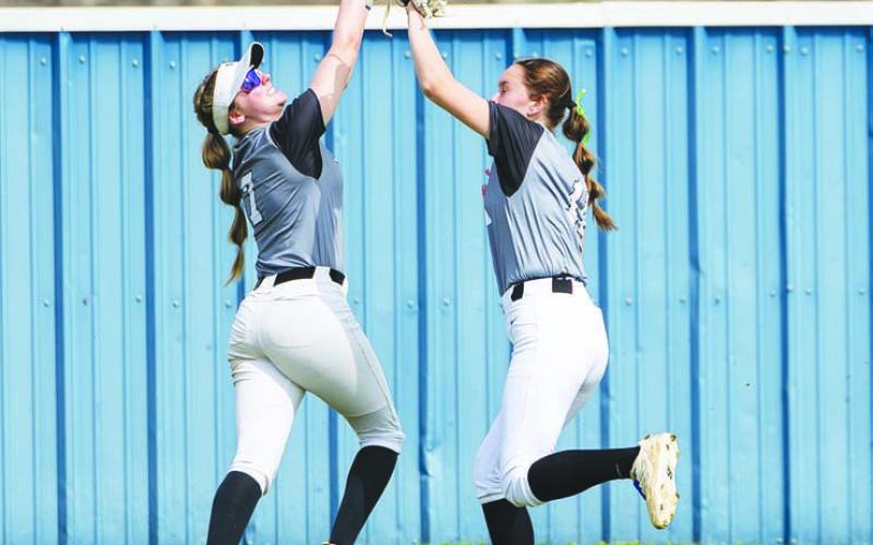 Stroud outfielders Sally Young (left) and Carlee Wiliams avoided a serious collision, but got the out against Deer Creek. Photo/Beth Young