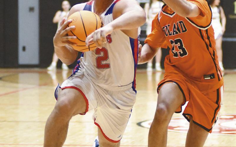 Jaydan Denson drives against Roland. Photo/Brian Blansett