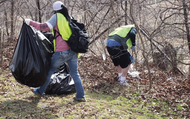 Three participants in the community sentencing program through Oklahoma Court Services pick up trash along Route 66 on Feb. 25. OSC arranges such activities at least once a month to help participants give back to the community. Two other groups did trash pick-up in Wellston and Stroud. Photo/Emily Kalka