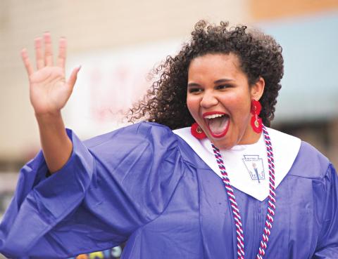 Jayla Campbell waves during Chandler’s graduation parade. Photo/Brian Blansett