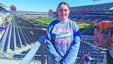 Chandler senior Ashlee Beatty poses in Camping World Stadium before the start of the Cheez-It Citrus Bowl on Jan. 1. Beatty has been the CHS mascot, Leo the Lion, for a year and a half and was invited to perform in the pregame and half-time shows at the bowl game as part of the All-American squad. She spent several days in Orlando learning the routines and preparing for the performances. Photo/Jennifer Pryor