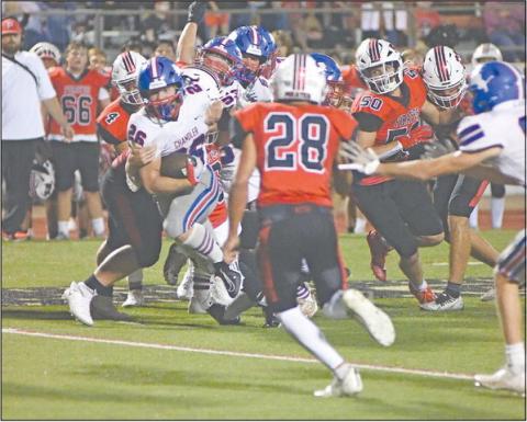 Chandler’s Carson Clagg (26) tows a Poteau defender for some yardage in the second half. Photo/Brian Blansett