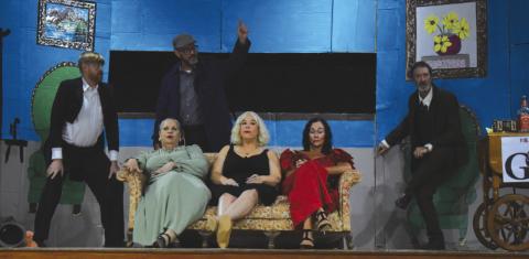 Chris Reed (standing, center) makes a point during the Friday night performance of “Drop Dead!” in Stroud. From left to right: (Standing) Tyler Peters, Reed and David Timmons; (Seated) Dani Skelton, DaNae Peters and Tawny K Duren. Photo/Emily Kalka