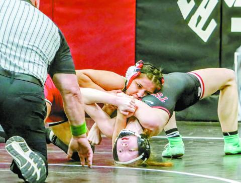McLoud’s Yazmin Nevarez (red headgear) dominates Tuttle’s Poet Smathers en route to a pin during the Class 5A regional wrestling tournament at Weatherford last week. Nevarez won the regional and helped McLoud to a team championship. She will lead a contingent of 25 area wrestlers to the state tournament in Oklahoma City this weekend. Photo/Jennifer Pryor