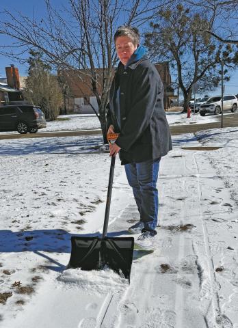 Deanna Trippler of Chandler took advantage of warmer temperatures on Friday to shovel and scrape the ice from her sidewalk. Photo/Brian Blansett