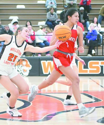 Wellston’s Savanah Gaylord (21) tips the ball away from Wetumka’s Jaclean Fish (1) during the Class A district finals Saturday night in Wellston. The win left the No. 9 Lady Tigers with a 24-2 record going into this week’s regional tournament. Photo/Brian Blansett