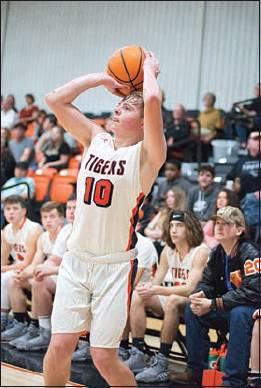 Colton Baldwin, above, lofts a three-point attempt for Wellston against Oilton.