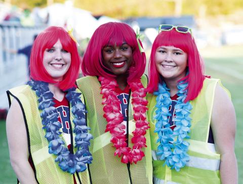 Lizzy Kliewer, Brooklyn Hammon and Logan Allen broke out the Hawaiian leis for Friday night’s game between Chandler and Metro Christian and then accessorized them with pink hair and safety vests. Photo/Brian Blansett