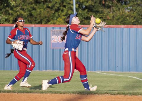 Chandler second baseman Halle Herrmann makes a running catch of a pop fly during the Lady Lions’ win over Wellston on Monday. Backing up is right fielder Hope Crews. Photo/Brian Blansett