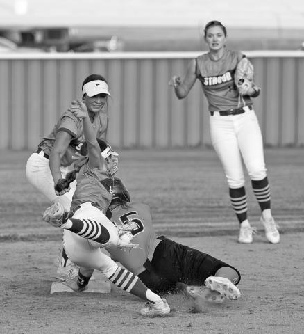 Above, Peyton Davis dives to tag Cushing’s Gracyn Presley (15) during action at Stroud last week. Stroud’s Adalyn Lum pirouettes on second base as Camryn Wilson looks on in the background. Presley got in safely. Photo/ Beth Young. Below, Ruthie Capps attempts a bunt in the bottom of the 10th in Chandler’s 1-0 win over Kiefer. Photo/Shelley Haley.