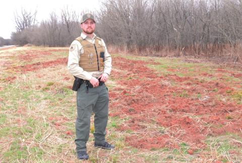 Game Warden Jacob Harriet along Highway 18, where wild hogs have rooted up the right of way in search of food. Photo/Brian Blansett