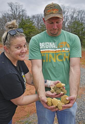 Charla Munn and Chris Cole, Chandler residents, hold some of the 95 morels they foraged on Sunday, Mar. 31, on their property. The two have been hunting morels since they were children and go out as much as they can during the short morel season. Photo/Emily Kalka