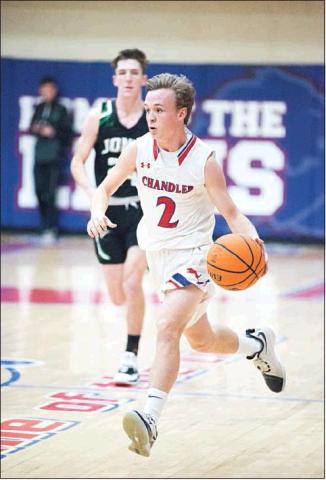 Above, Dalton Alsip brings the ball across the centerline for the Lions and,