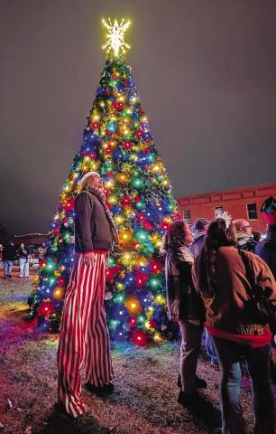 Tate Monroe (on stilts) and other residents watch fireworks on the Lincoln County Courthouse lawn Saturday night during Chandler’s Christmas parade and tree-lighting festival. Santa and Pistol Pete took photos with children, and a Christmas market was held in the Lincoln County Museum of Pioneer History. There were also food trucks and gingerbread house-building in the courthouse. For more photos, see page 1B. Photo/Jennifer Pryor