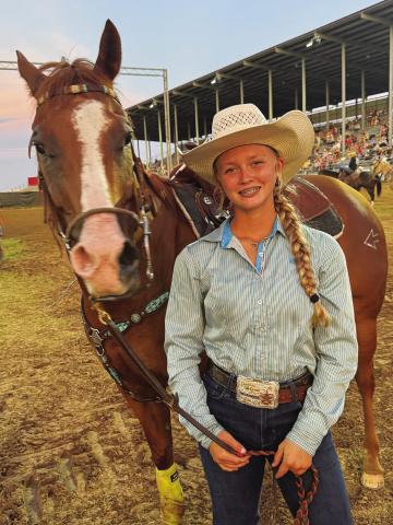 Marley Miller and her horse, Pete, pose after a run in the barrel racing Thursday night at the International Finals Youth Rodeo in Shawnee. Photo/Brian Blansett