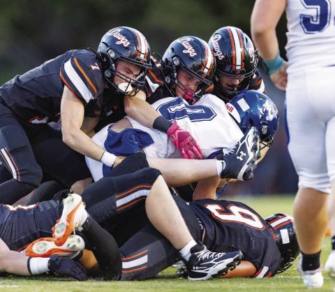 From left, Bulldogs Adam Tweedy, Reece Murfin and Chace Buchanan combine to stop a Depew ball carrier. Photo/Rick Hester