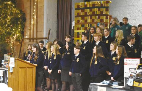 Junior Katie Wright, treasurer of the Chandler High School FFA chapter, welcomes guests to the Second Annual Chandler Ag Booster Club Dinner and Auction on Jan. 25 at the Route 66 Interpretive Center. Over 40 lots were up for grabs in the live auction, with more items in the silent auction. The money was raised to help support Chandler FFA and 4-H students with scholarships, trips, activities and more. Photo/Emily Kalka