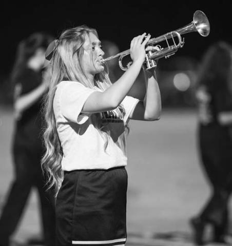 Above, Maleah Blanksenship left the cheer squad to join the Pride of Meeker Band during its performance. Photo/Rick Hester