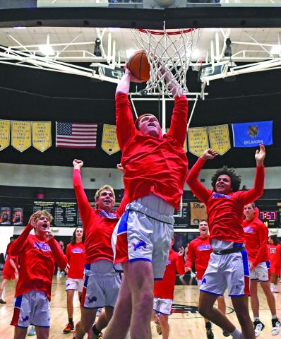 Chandler’s Alec Jackson throws down a dunk to start warmups in the 66 Conference tournament at Okemah last week. Jackson got a dunk later in the game against McLoud, and the Lions reached the tournament finals, where they fell to Seminole in overtime. Photo/Brian Blansett