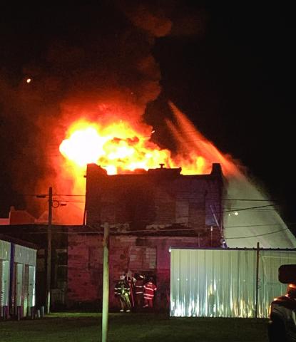 Firefighters pull off the back door of Horn’s Antiques in Stroud Monday night. Photo/Baylee Blancarte