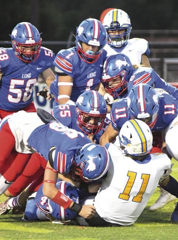 In a visual metaphor for the game, seven Chandler defenders combine to tackle Bethel quarterback Cale Duncan (11). Involved are Hunner Robinson (44) on the ground, Coniah Ritchie (16), Kaled Foster (55), Ty Garver (11), James Fine (58), Cruz Jackson (1) and Zeke Kuczinksi (67). Photo/Brian Blansett
