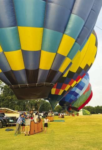 Crews inflate their hot air balloons Friday morning at the Ninth Annual Citizen Potawatomi Nation Balloon Fest. The three-day event featured two dozen hot air balloons, balloon rides and entertainment. Photo/Brian Blansett