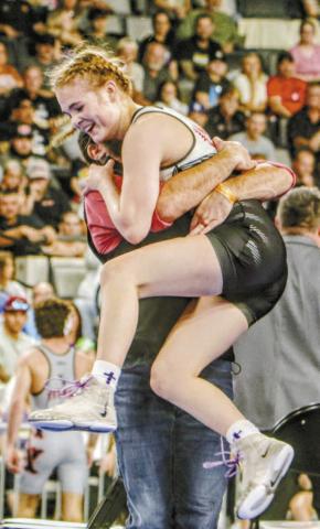 McLoud sophomore Carli Sisco celebrates her second consecutive state champi-See onship with coach William Winters. Photo/Jennifer Pryor