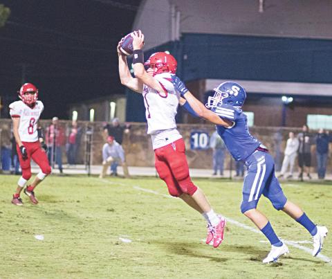 Prague’s Trip Davis grabs an interception in the second half to stop a Stroud drive. Photo/Brian Blansett