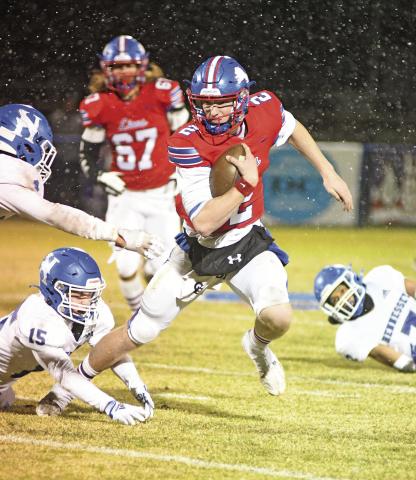 Chandler quarterback Alec Jackson ran over, through and around would-be tacklers during a play in the first half Friday night. Jackson ran a score and threw for three more to pace the Lions’ offensive outburst. Photo/Brian Blansett