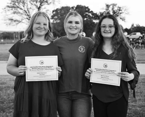 Kaci Dennis, Communications Outreach Coordinator from CVEC (middle), stands with Chloe Gross from Chandler (left) and Addison Richardson from Prague at the 25th Annual Flag Retirement Ceremony on Oct. 14. The two students won CVEC’s annual flag essay contest in the middle school (Gross) and high school (Richardson) divisions. Photo/CVEC