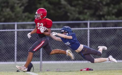 Above, Caleb Hawkins (22) outruns the grasp of a Bethel defender during a four-way scrimmage Friday at Tecumseh. The Cougars open their regular season Friday at home against traditional power Marlow. Below left, J.J. McClain (4) stiff-arms a Bridge Creek tackler and takes a mitt to the face. Bottom left, NRC quarterback Landon Kelough (7) sets up to pass against Tecumseh. Below right, Drake Clemons tries to turn out of the grasp of a Bethel tackler. Photos/Rick Hester