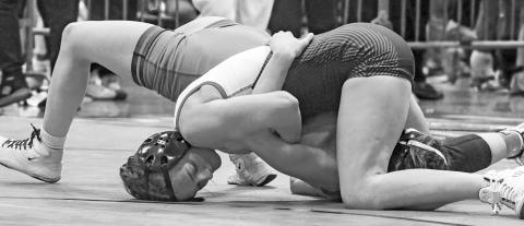 Chandler sophomore Lizzy Pryor (facing camera) dominates her match against Diana Lomeli from Bridge Creek at the Midwestern Conference meet. Pryor won with a fall and took fifth in her class. Photo/Jennifer Pryor - For more photos from the tournament, see Page 1D