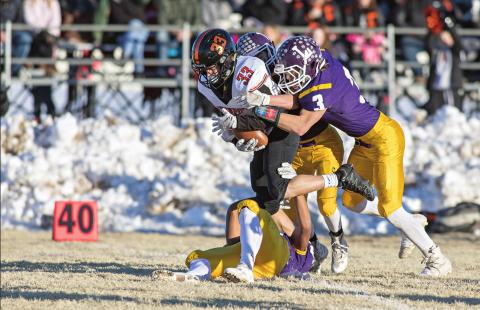 Davenport’s Colton VanFossen (33) picks up some yards for the Bulldogs before being tackled by Peyton Freeman (3) and his associates. Photo/ Rick Hester.