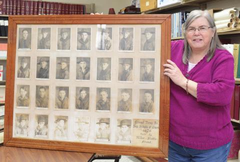 Librarian Marsha Morgan with one of the oversize photos, which is of Stroud Boy Scouts in 1926. Photo/Brian Blansett