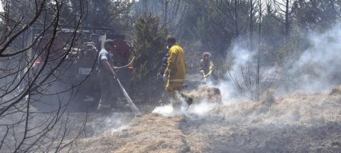 Firefighters work to put out a hay bale at a large grassfire near Kendrick on Aug. 20. Seven fire departments responded to the call. Photo/Emily Kalka
