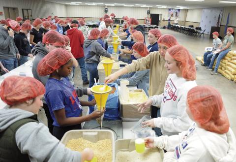 Chandler High School students from five organization - Family, Career and Community Leaders of America; varsity cheer, varsity pom, Future Farmers of America and Business Professionals of America - sorted and filled 30.024 meal packages for Stamp Out Starvation on Friday. Stamp out Starvation is a non-profit organization headquartered in Cherokee, Ok. For more photos and information, please see Page 2A. Photo/Brian Blansett