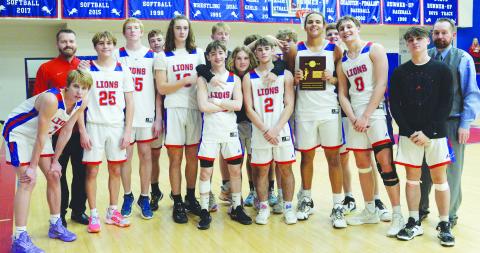 The Chandler Lions pose with their district championship trophy after beating Beggs, 55-46, Friday. Now 13-10 for the season, the Lions will play Washington Thursday night.