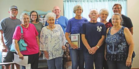 Classmates and McLoud alumni members present the Redskin Remember plaque to Pamela Griffin. Photo/provided