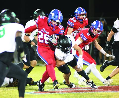 Chandler’s Carson Clagg (26) grinds for some hard yardage against Jones. Also pictured are Caleb Sawatski (8) and Corbin Hollon (88). Photo/Brian Blansett