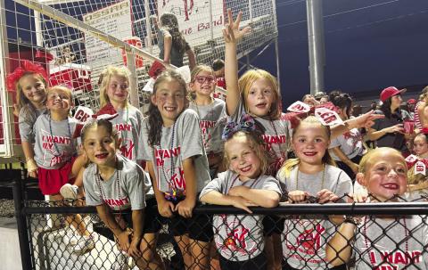Prague tiny cheerleaders wait to take the field and perform at halftime of the Red Devils’ football opener Friday night. Pictured are Layla Beyer, Emma Snyder, Hazel Forneris, Jayla Strickland, Avery Grounds, Scarlet Davenport, Iris Sedlacek, Bonnie Hinkle and Ava Ross. They ranged from kindergarten through second grade. Photo/Brian Blansett