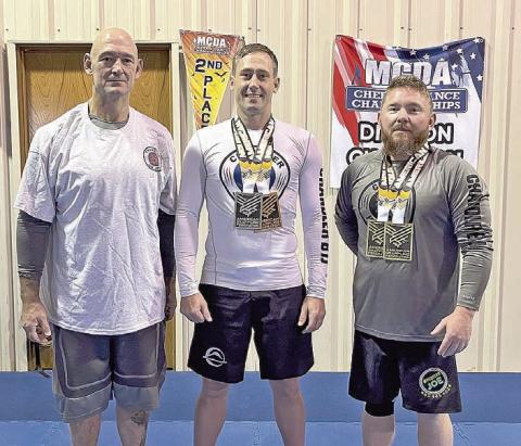 Shawn Brake won two gold medals and Nate Soderstrom won a silver and bronze at the American Grappling Federation OKC Open this month. Brake, right, won Gold in Gi and Gold in No-Gi. Soderstrom, center, won Silver in Gi, Bronze in No-Gi. They are pictured with Bret Smithey. Photo provided